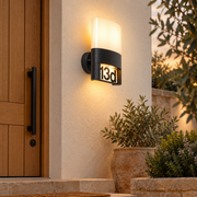 Aplique exterior LED negro con numeración de vivienda intercambiable, vista en ambiente instalado