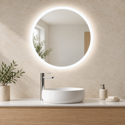 Espejo redondo de baño de 60 cm con aro LED blanco neutro encendido y un mando táctil